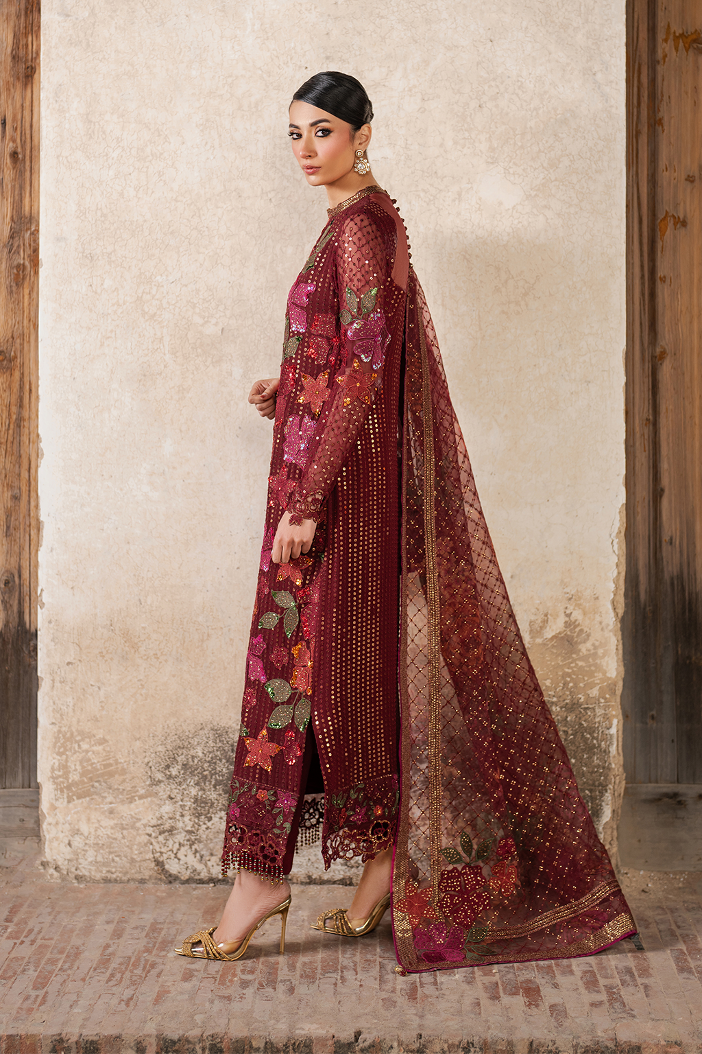 Side view of embroidered maroon chiffon dress with floral motifs, gold accents, and matching dupatta for women
