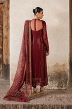 Close-up of detailed embroidery on maroon chiffon dress with floral and butterfly designs, gold thread, and embellishments