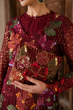 Close-up of embroidered maroon dress with floral sequin embroidery and matching clutch, traditional Pakistani outfit